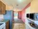 Kitchen with stainless steel appliances and view into living room at 7570 Berwick St, North Port, FL 34287