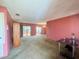 Spacious living room with light pink walls, carpeting, and a chandelier at 7570 Berwick St, North Port, FL 34287