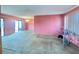 Living room features pink walls, carpeting, and access to a patio at 7570 Berwick St, North Port, FL 34287