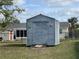 Grey storage shed in backyard with ramp at 7570 Berwick St, North Port, FL 34287