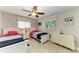 Guest bedroom with twin beds, nightstand, and window at 820 Via Tunis, Punta Gorda, FL 33950