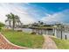 Landscaped backyard with canal access and brick walkway at 820 Via Tunis, Punta Gorda, FL 33950