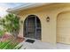 Front entry with decorative wrought iron door and sidelights at 820 Via Tunis, Punta Gorda, FL 33950