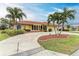 Front view of house with palm trees and a circular driveway at 820 Via Tunis, Punta Gorda, FL 33950