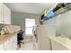 Laundry room with washer, dryer, and built-in workspace at 820 Via Tunis, Punta Gorda, FL 33950