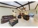 Living room with high ceilings, exposed beams, and a view to the pool at 820 Via Tunis, Punta Gorda, FL 33950