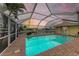 Relaxing pool area with screened enclosure and water view at 820 Via Tunis, Punta Gorda, FL 33950