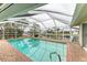 Inviting screened pool with canal view; spacious brick patio at 820 Via Tunis, Punta Gorda, FL 33950