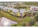 Aerial view of condo building with pond and parking at 2060 Willow Hammock Cir # 302, Punta Gorda, FL 33983