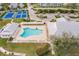 Community pool with surrounding lounge chairs and tennis courts at 2060 Willow Hammock Cir # 302, Punta Gorda, FL 33983