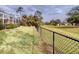 Backyard view showcasing a chain link fence and green lawn at 26191 Copiapo Cir, Punta Gorda, FL 33983