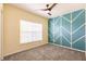 Bedroom with teal accent wall and ceiling fan at 2060 Willow Hammock Cir # 302, Punta Gorda, FL 33983