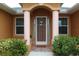 Front entrance with columns, decorative screen door, and lush landscaping at 26191 Copiapo Cir, Punta Gorda, FL 33983