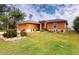 Single story house with orange exterior and manicured lawn at 26191 Copiapo Cir, Punta Gorda, FL 33983