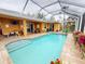 Enjoy this screened pool area with patio furniture and tropical plants at 26191 Copiapo Cir, Punta Gorda, FL 33983