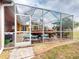 Screened pool and patio area with lounge chairs and potted plants at 26191 Copiapo Cir, Punta Gorda, FL 33983