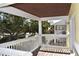 View from an outdoor covered balcony overlooking green space and other outdoor living spaces at 108 Pompano Se Dr # D, St Petersburg, FL 33705