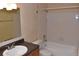 Bathroom featuring tub-shower combo, toilet, vanity, and tile flooring at 108 Pompano Se Dr # D, St Petersburg, FL 33705