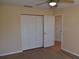 Neutral bedroom with carpet and a double door closet, plus standard door at 108 Pompano Se Dr # D, St Petersburg, FL 33705