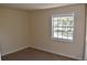 Neutral bedroom features carpet and a window overlooking the exterior landscape at 108 Pompano Se Dr # D, St Petersburg, FL 33705