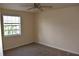 Spacious bedroom with ceiling fan and window at 108 Pompano Se Dr # D, St Petersburg, FL 33705