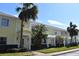 Exterior of charming yellow building with palm trees and lush landscaping at 108 Pompano Se Dr # D, St Petersburg, FL 33705