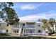 Bright yellow two-story condo building with white railings and shutters under a partly cloudy blue sky at 108 Pompano Se Dr # D, St Petersburg, FL 33705