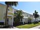 Charming yellow townhome with well-manicured landscaping offering curb appeal and a welcoming exterior at 108 Pompano Se Dr # D, St Petersburg, FL 33705