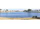 Picturesque view of a lake with a water feature surrounded by green lawns and comfortable bench seating at 108 Pompano Se Dr # D, St Petersburg, FL 33705