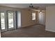 Neutral living room featuring ceiling fans, a large window with French doors, and carpeted floors at 108 Pompano Se Dr # D, St Petersburg, FL 33705