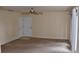 Carpeted living room with a ceiling fan, double door closet and view to the exterior at 108 Pompano Se Dr # D, St Petersburg, FL 33705