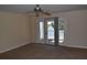 Living room featuring sliding glass doors to balcony with lake view, tan carpet and neutral walls at 108 Pompano Se Dr # D, St Petersburg, FL 33705