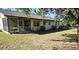 Spacious backyard with screened patio and grassy area at 1174 Victoria Ave, Port Charlotte, FL 33948