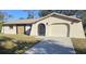 Single-story house with a large driveway and mature trees at 1174 Victoria Ave, Port Charlotte, FL 33948