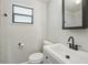Updated bathroom with modern vanity, black fixtures, and tiled shower at 1219 Ansin St, Punta Gorda, FL 33950