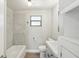 Updated bathroom with grey vanity, white tub, and patterned tile at 1219 Ansin St, Punta Gorda, FL 33950