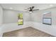 Spacious bedroom with grey walls, wood-look flooring, and ceiling fan at 1219 Ansin St, Punta Gorda, FL 33950