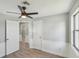 Comfortable bedroom with grey walls, wood-look flooring, and ceiling fan at 1219 Ansin St, Punta Gorda, FL 33950