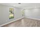 Bright bedroom with grey walls, wood-look flooring, and ceiling fan at 1219 Ansin St, Punta Gorda, FL 33950