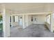 Covered carport with concrete flooring and access to the home at 1219 Ansin St, Punta Gorda, FL 33950