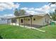 Side view of house with covered patio and yard at 1219 Ansin St, Punta Gorda, FL 33950