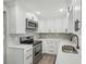 Updated kitchen with white cabinets, stainless steel appliances and quartz countertops at 1219 Ansin St, Punta Gorda, FL 33950