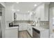 Renovated kitchen boasts white cabinets, stainless steel appliances, and stylish backsplash at 1219 Ansin St, Punta Gorda, FL 33950