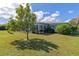 Spacious backyard with lush grass and a partially visible patio at 125 Severin Se Rd, Port Charlotte, FL 33952