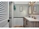 Double vanity bathroom with updated fixtures and light green walls at 125 Severin Se Rd, Port Charlotte, FL 33952