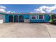 Bright blue house with arched entryway and white garage door at 125 Severin Se Rd, Port Charlotte, FL 33952