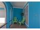 Cozy front porch with two green chairs and a view of the entryway at 125 Severin Se Rd, Port Charlotte, FL 33952
