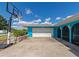 Attached garage with a white door and stone accents at 125 Severin Se Rd, Port Charlotte, FL 33952