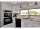 Modern kitchen with stainless steel appliances and white cabinets at 125 Severin Se Rd, Port Charlotte, FL 33952