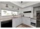 Bright kitchen with white cabinets and granite countertops at 125 Severin Se Rd, Port Charlotte, FL 33952